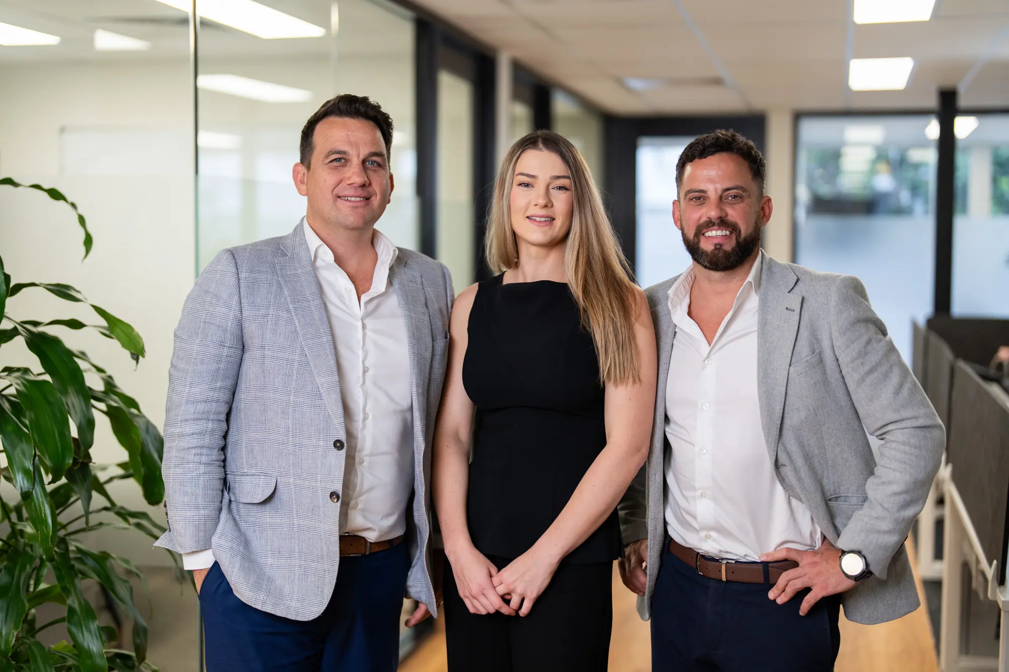 3 colleagues posing at the office