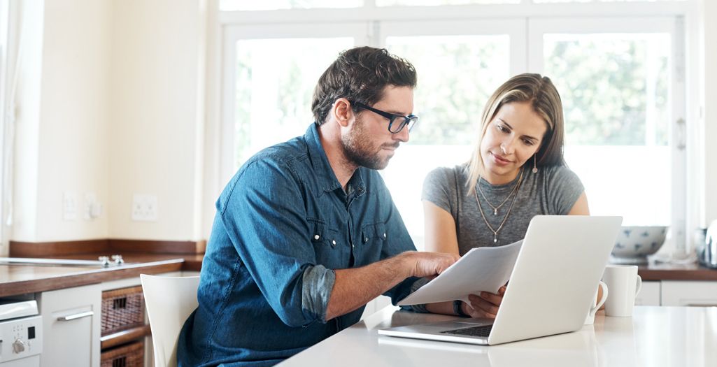 a man discussing paperworks to a woman