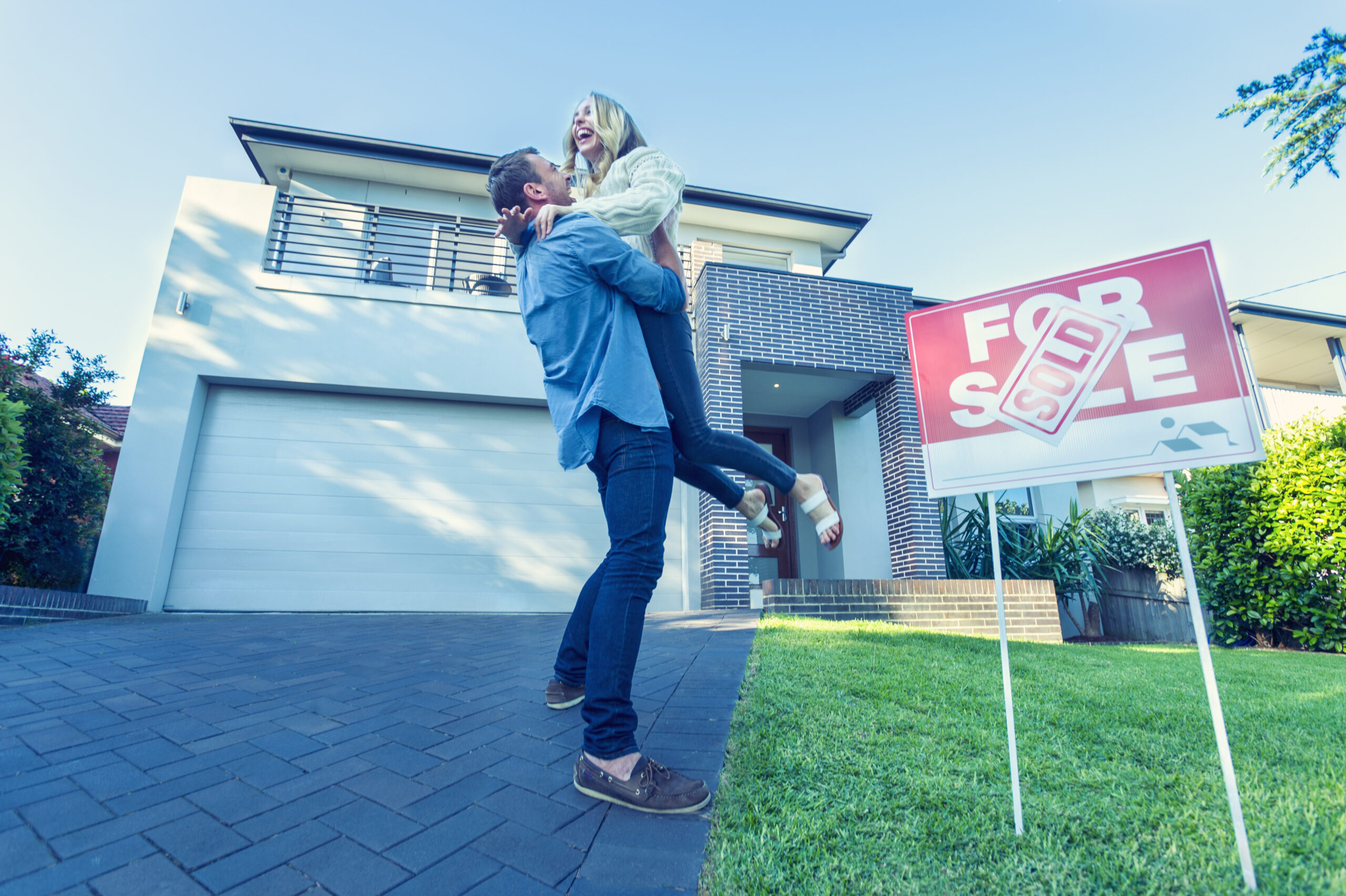 Couple standing in front of a new home