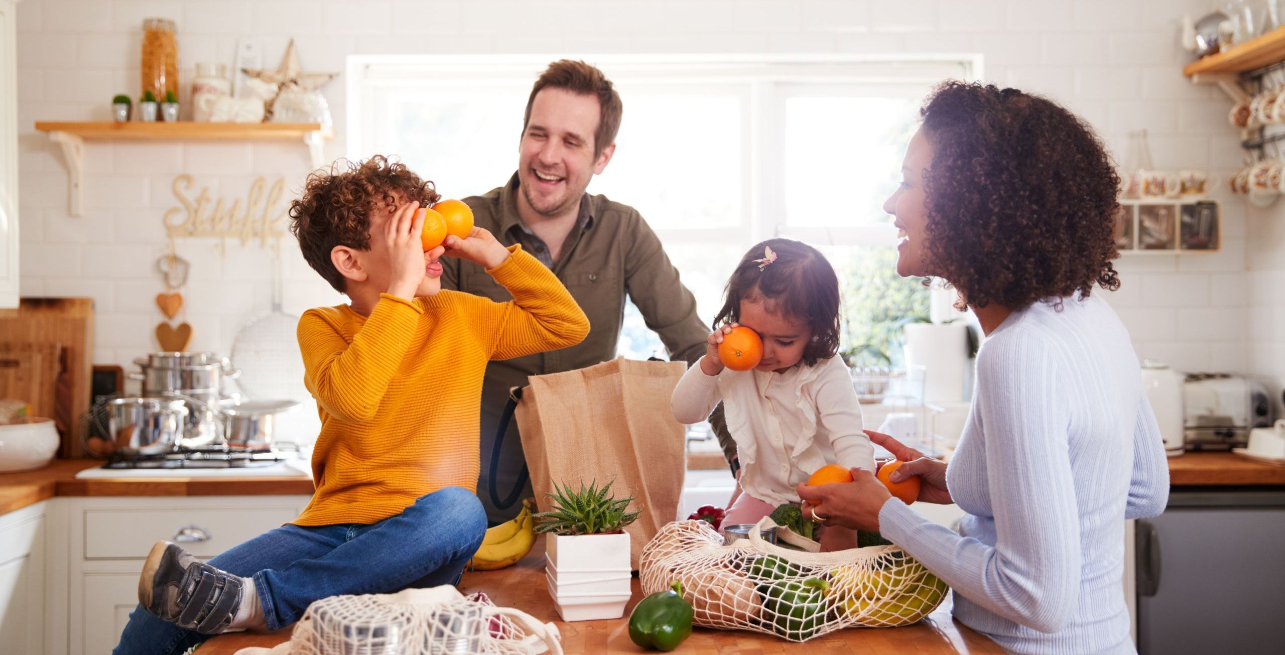 family in the kitchen with groceries