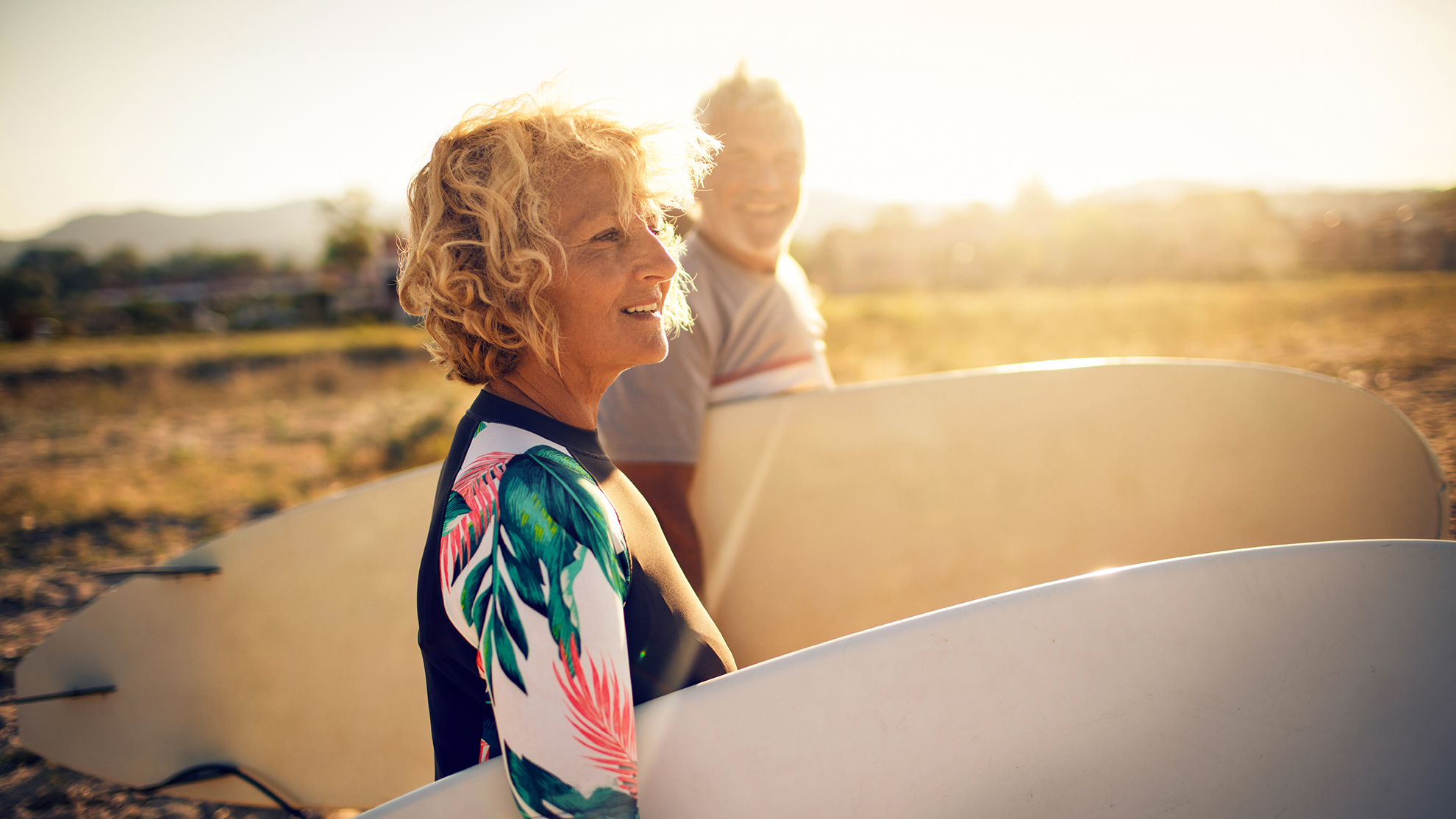 Very active senior couple getting ready to surf