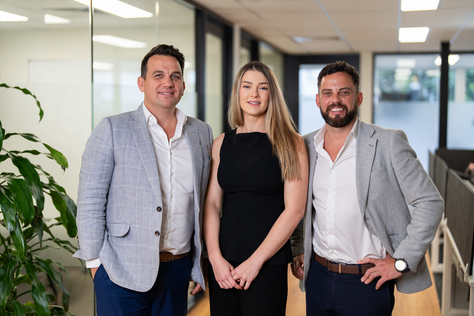 3 colleagues smiling at the office