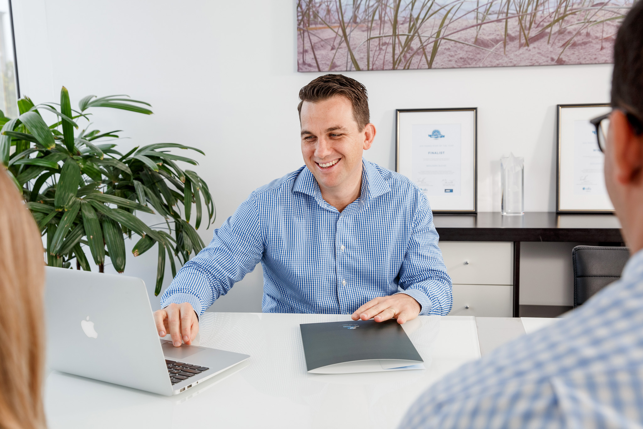 male professional in a meeting smiling