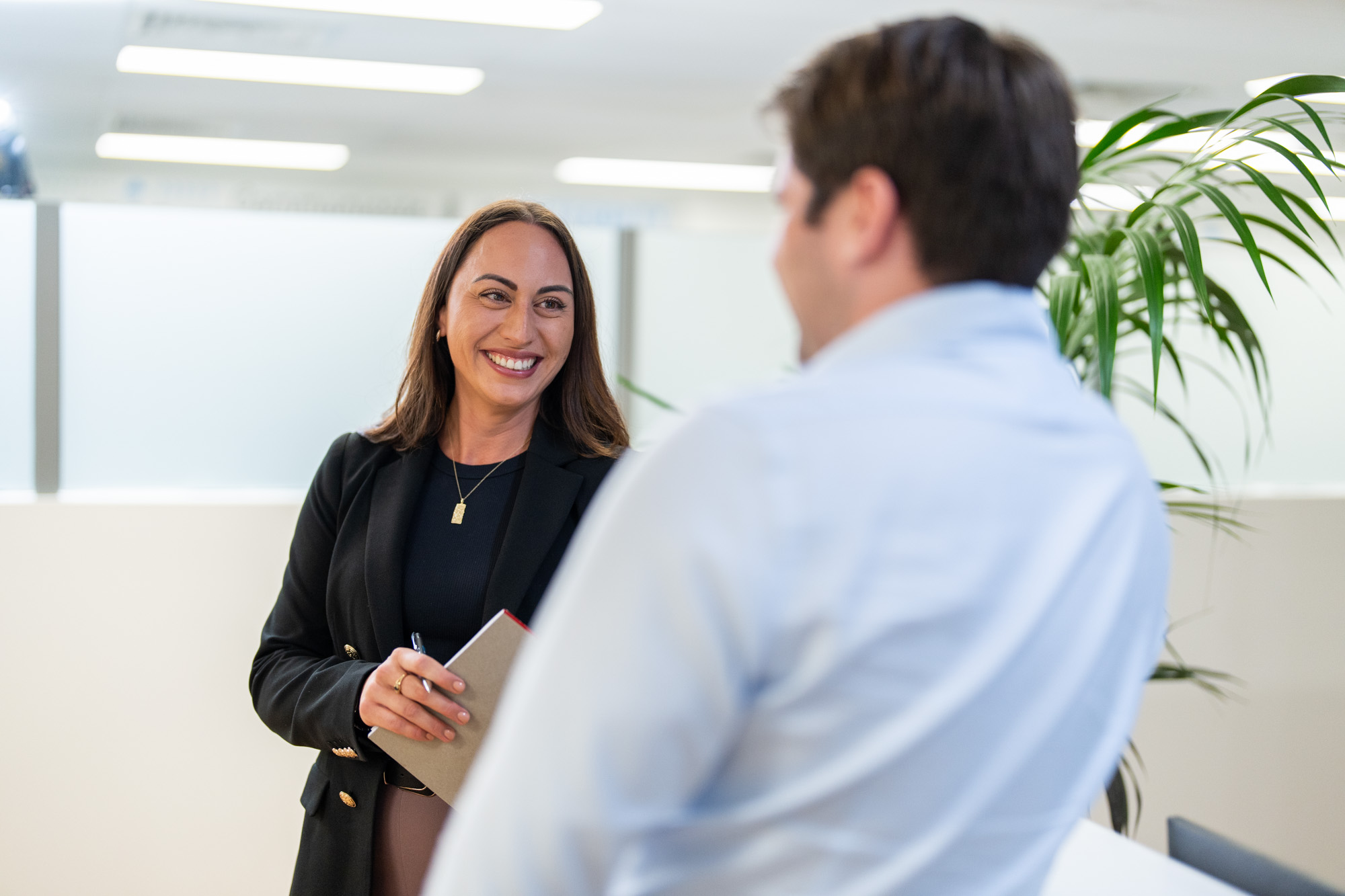 a man and woman speaking at the office