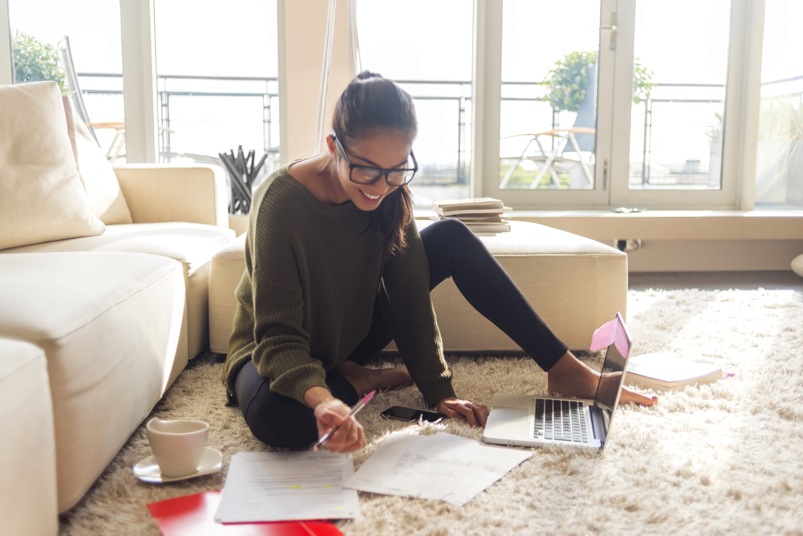 smiling young woman studying in her living room